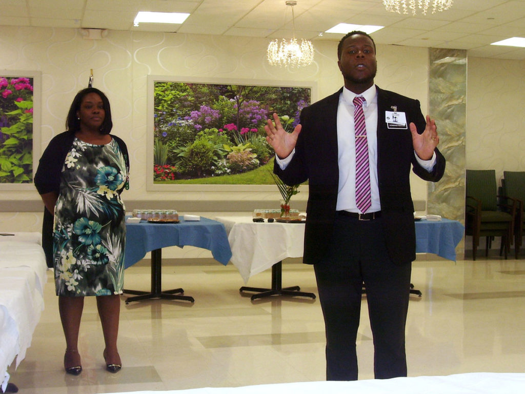 A well dressed man and woman enjoying the employee of the month celebration.