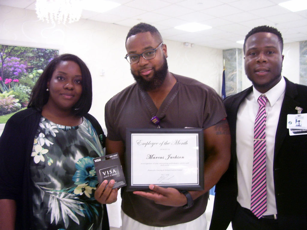 Posing for a photo at the employee of the month celebration.