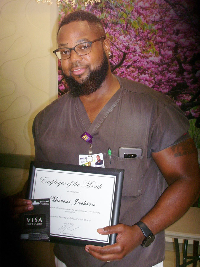 Employee of the Month Posing With Award